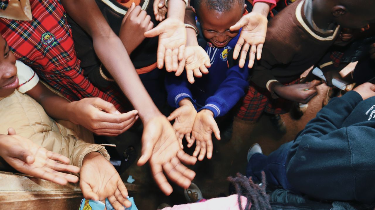 Crafting Captivating Headlines: Your awesome post title goes here A diverse group of children reaching out their hands, symbolizing unity and hope.
